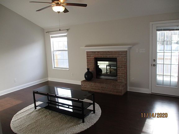 Living room with access to deck. Cathedral ceilings in living room.