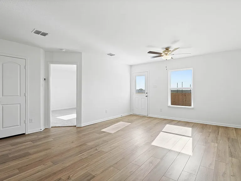 Spacious family room with vinyl flooring.