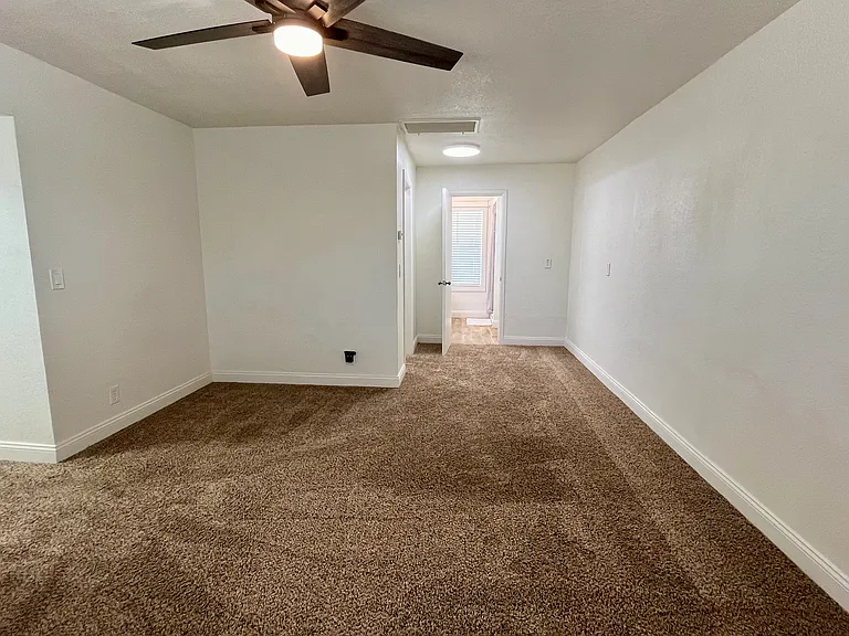 Large space master bedroom with new fan, his and her closets