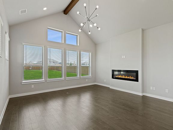 Living room in the Rainier home plan by Trophy Signature Homes - REPRESENTATIVE PHOTO