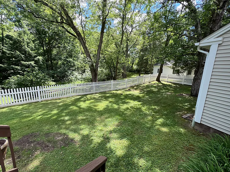 Backyard with white fence.