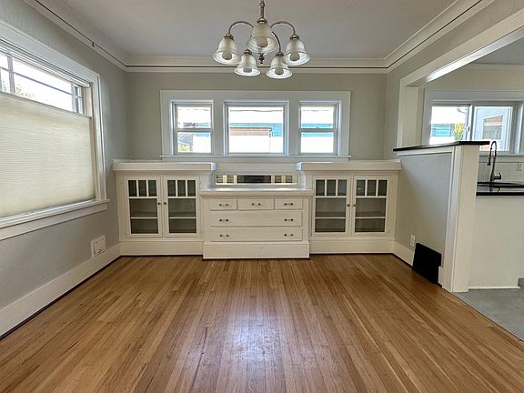 Dining room with built-ins, picture window and chandelier right off of the kitchen.