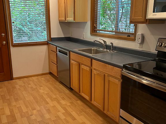 Kitchen with new or newer appliances. Very quiet Kitchenaid dishwasher with a third rack.