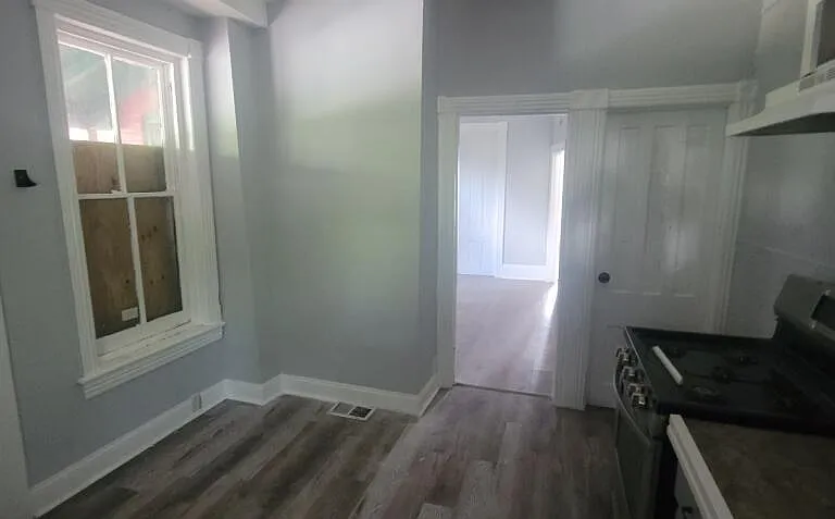 View from the kitchen (rear) to the front of the house. The back door is on the left. Door on the right leads to the open, finished basement.