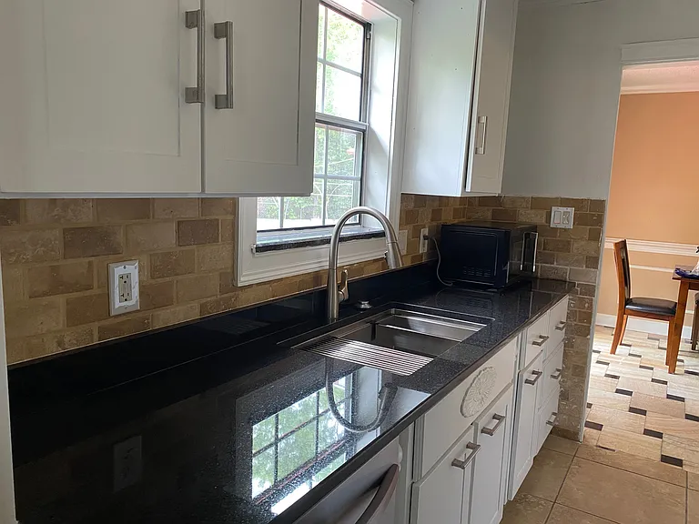 New countertops enhance the kitchen with a clean, updated appearance and functional workspace