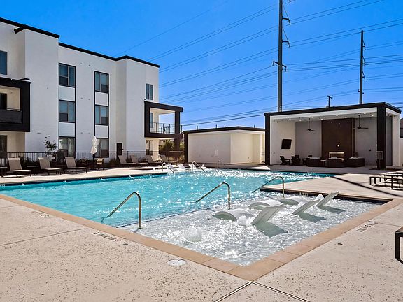 Relaxing Poolside Seating and Covered Social Areas at Rhythm Apartments