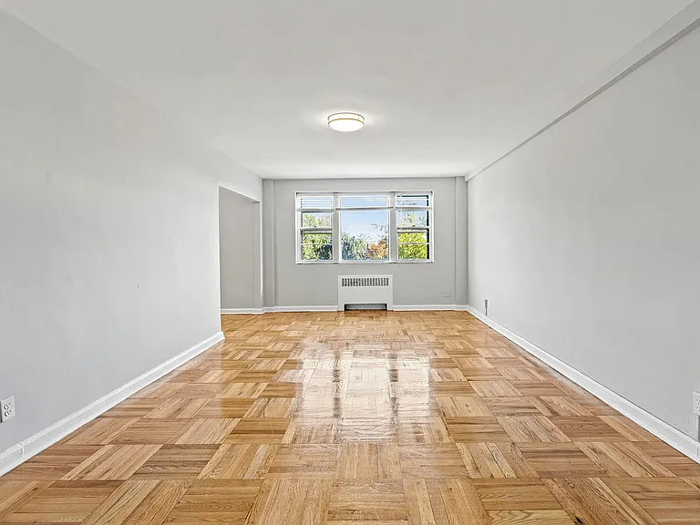 Enjoy abundant natural light in this beautifully polished hardwood-floored living room.