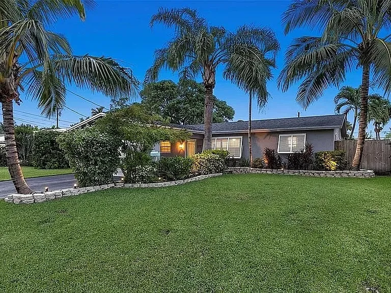Front of House Provides Spacious Driveway & Elegant Landscape Lighting at Dusk