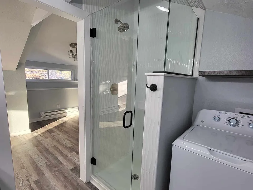 Shower with black hardware and custom glass enclosure