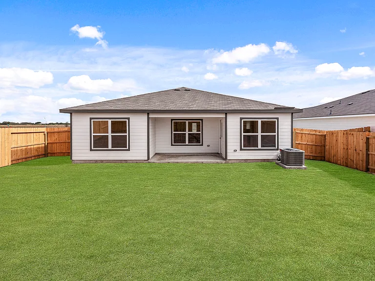 Spacious backyard with a covered patio.