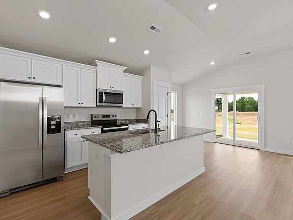 The kitchen has designer wood cabinetry
