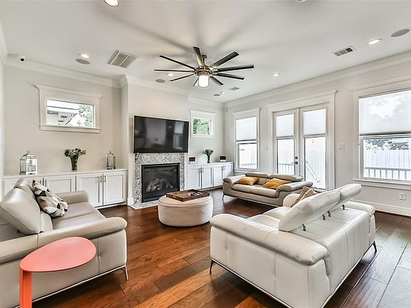 Another view of the family room which features fireplace, custom built ins and access to the backyard.