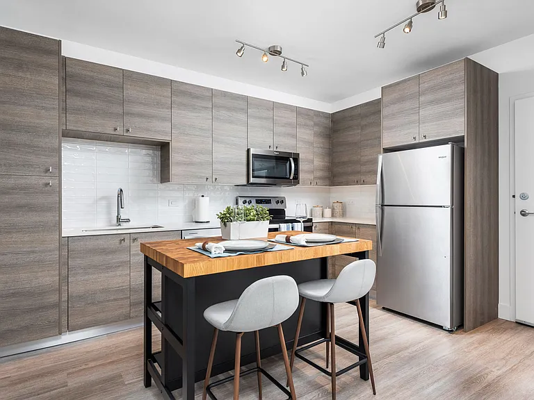 Kitchens feature custom cabinetry and quartz countertops