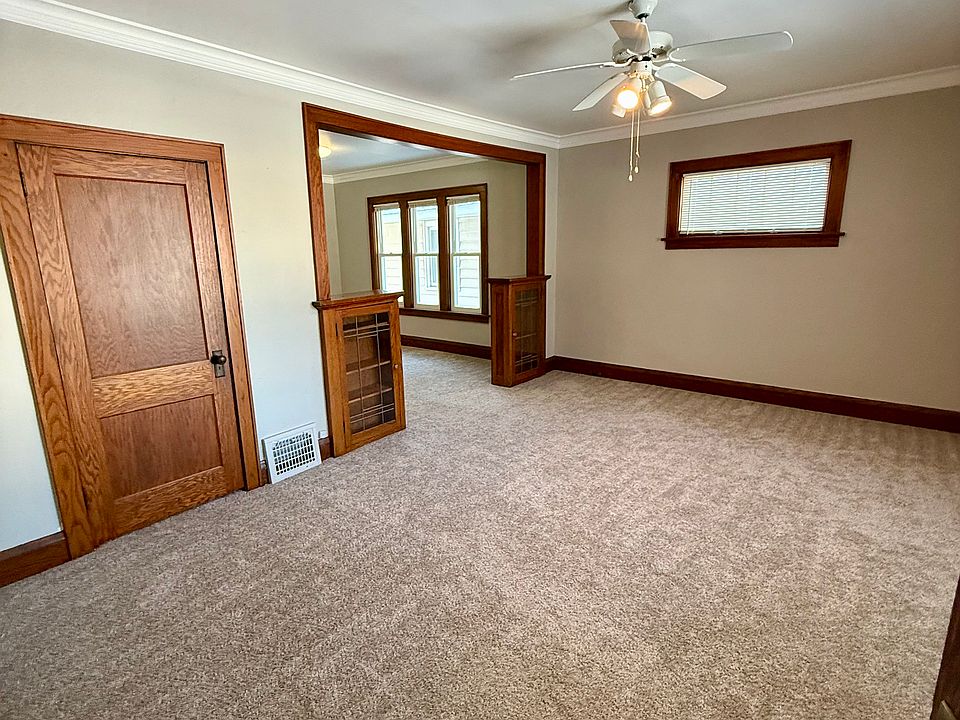 Large family room with lots of morning light and original oak built-in bookcases.