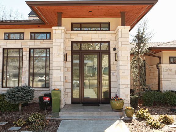 A closer look at the front entry lets us view the stone exterior & great attention to detail. What a grand front entrance!