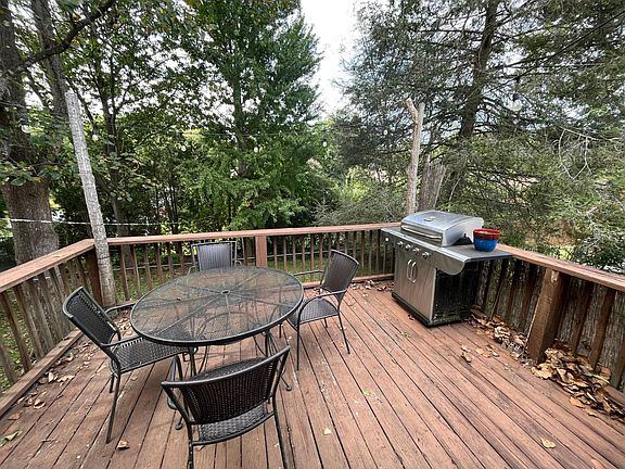 High back deck up in the trees, accessed through French doors to the kitchen.