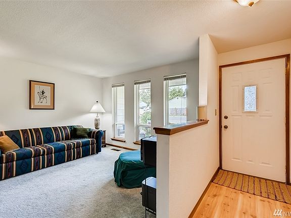 Enter to a formal living room with fireplace