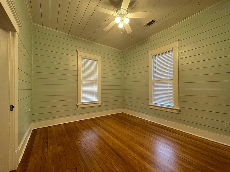 Front bedroom features refinished pine floors.
