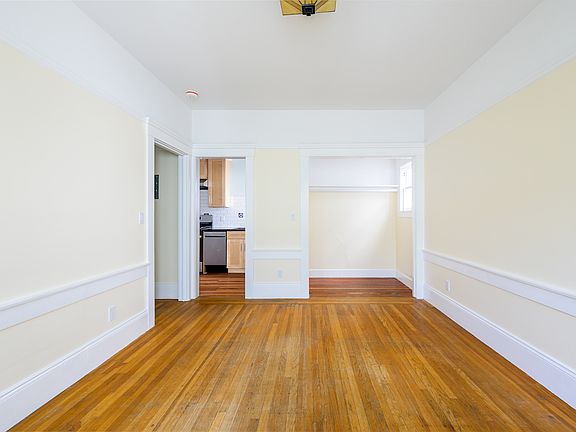 studio facing open closet and kitchen