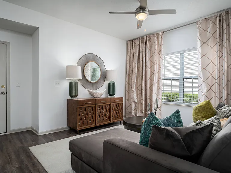 A modern living room with warm finishes and comfortable design, made to feel like home from the moment you walk in.
