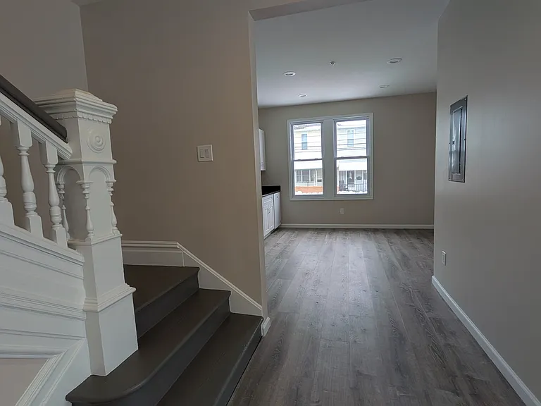 stairway leads to kitchen/breakfast area