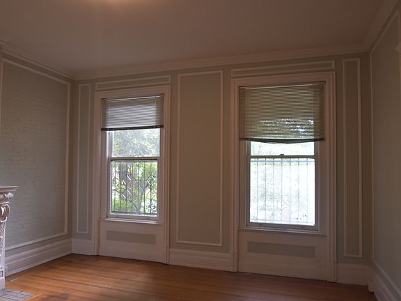 Spacious living room windows overlooking the courtyard