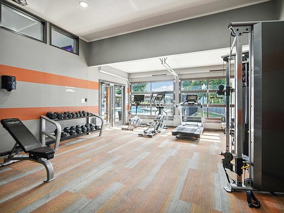Spacious gym with strength and cardio equipment at Ovation Apartments in Austin, TX, offering residents top-tier workout amenities.