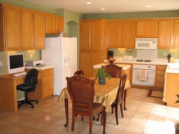 The large open kitchen with island and built-in desk.