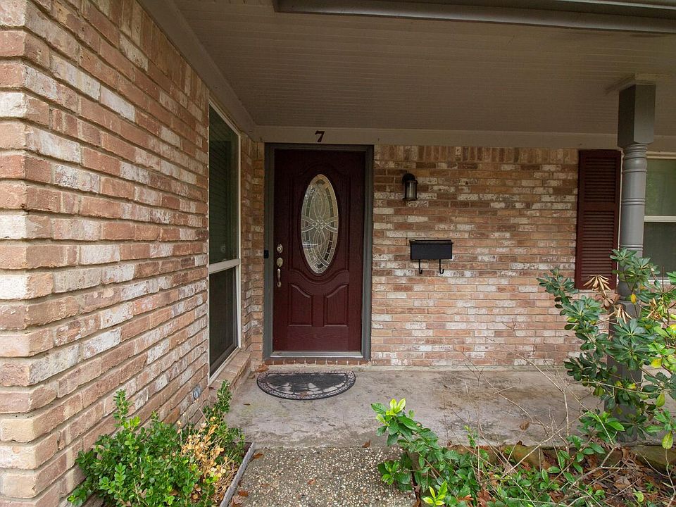 The front entry sits under a porch.