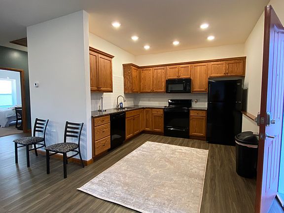 Kitchen with granite counters and appliances as shown.