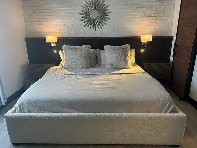 King-size bed with night stands lend scale to the room. Not shown is a desk and chair (also in the room).