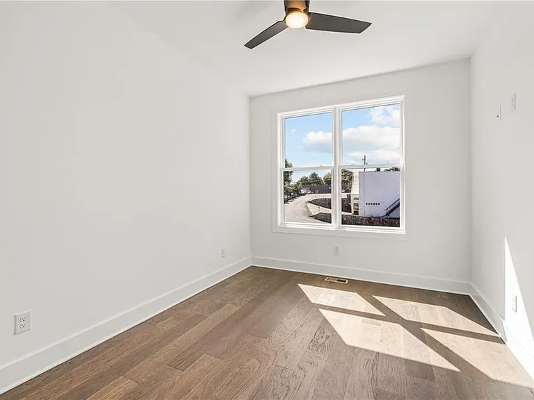 Guest Bedroom (Note: Actual unit has light wooden floors and upgraded fixtures / appliances)