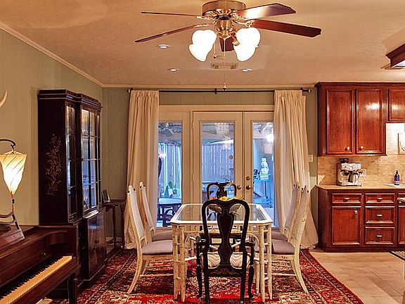 View to the dining room with French doors that allow plenty of natural light in making this space pe