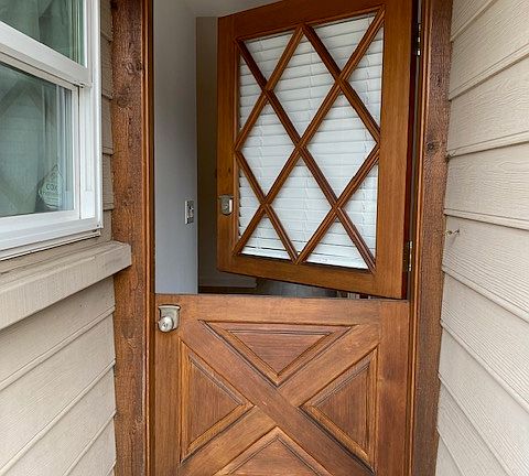 Charming dutch front door to let the ocean breezes flow thru the bungalow.
Front door is elevated above street level which makes the front door being open , private.