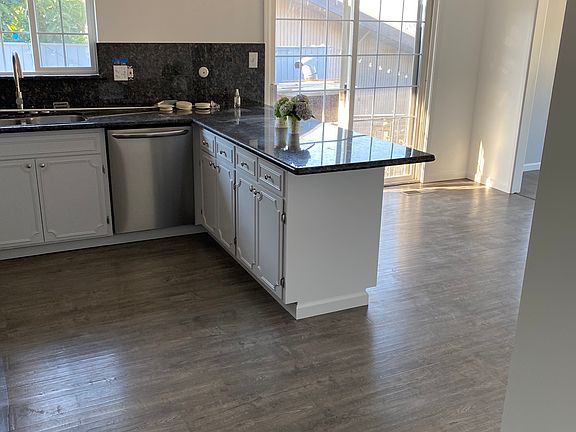 Kitchen, Dining Area and Access to Patio / Front Yard and Back Yard