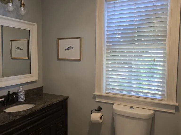 Granite Counter top cabinets and tiled bathroom with Tub/Shower combo.