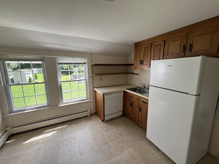Kitchen has dishwasher, refrigerator, stove.