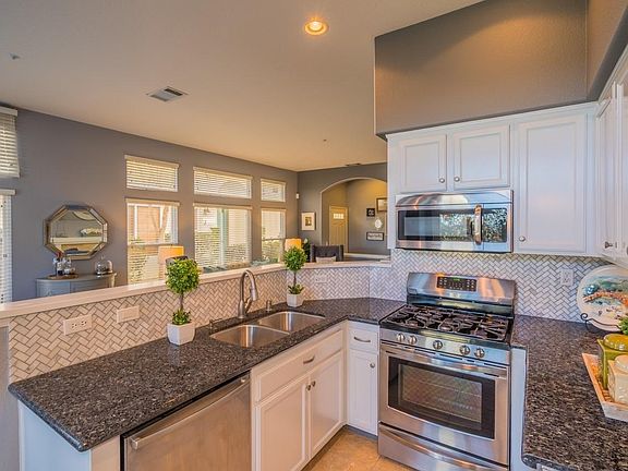 Kitchen has upgraded tile and granite countertops.