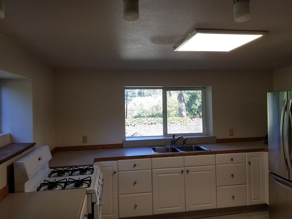 Kitchen with windows on 2 walls, breakfast bar.