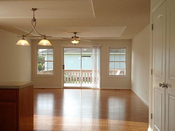 View as you enter front door, looking towards the deck on the back of the house. The neighbors house does not have windows on the side next to the deck, which adds additional privacy. Notice the additional detail on the ceiling and the arch detail on pa