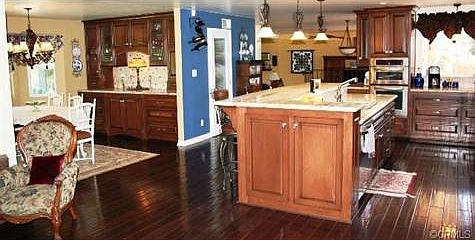 View of Gourmet Kitchen and Dining Room with Built-ins