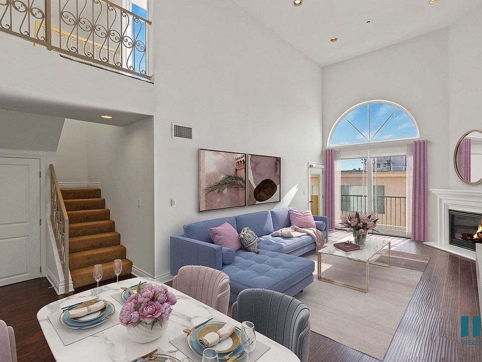 Spacious Living Room with Large-Size Windows, Balcony, Fireplace, and Vinyl Flooring