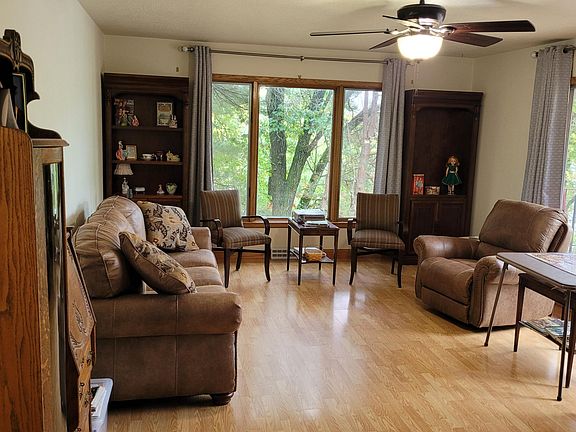 Living room has 2 large picture windows over looking the woods and water.