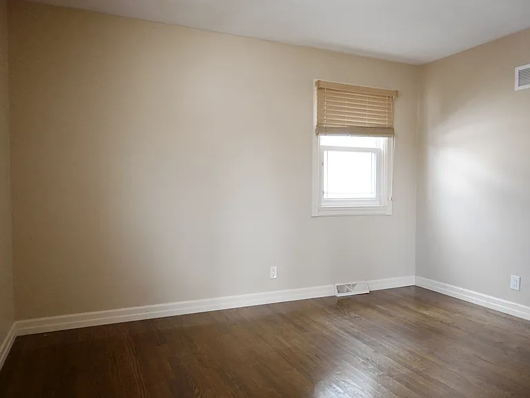 Bedroom with wood flooring at Square 131 5-Plex.