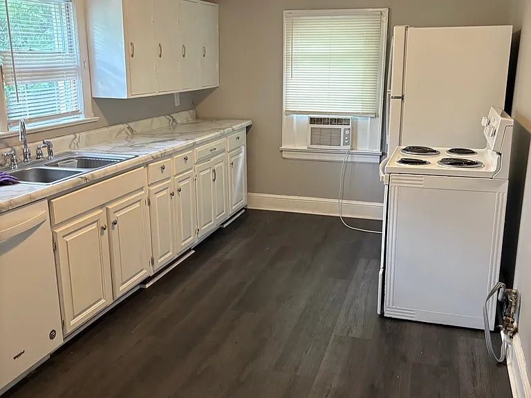 Kitchen w/ Designer Crystal Lighting. New Luxury Vinyl Tile. Appliances include NEW Refrigerator, Stove, Dishwasher and Wine Frig! Lots of Cabinets and Countertop Space! New Sherwin Williams Designer French Gray!