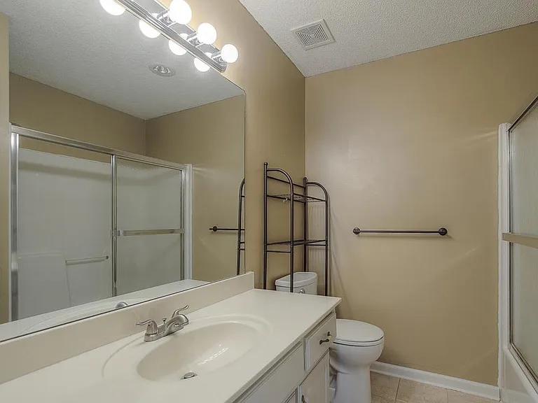 The shared bath is large and modern.