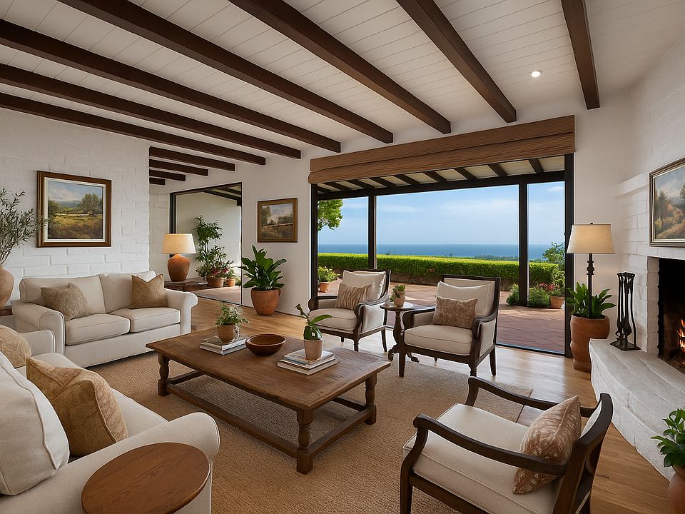 Sweeping views from this elevated hancienda with restored adobe walls enshrouding the living room, adding warmth, texture, and a timeless sense of place.