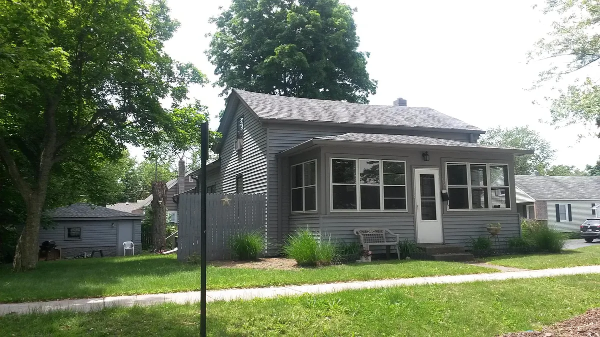Side yard. Front 3 seasons porch. - 402 Institute St
