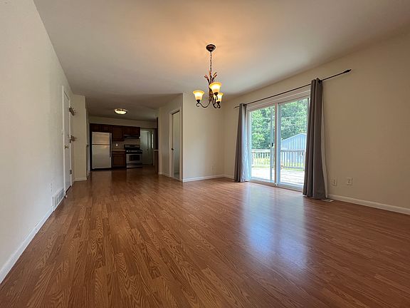 Dining Room leads into kitchen with half bathroom between rooms and mud room off to the left that leads into garage