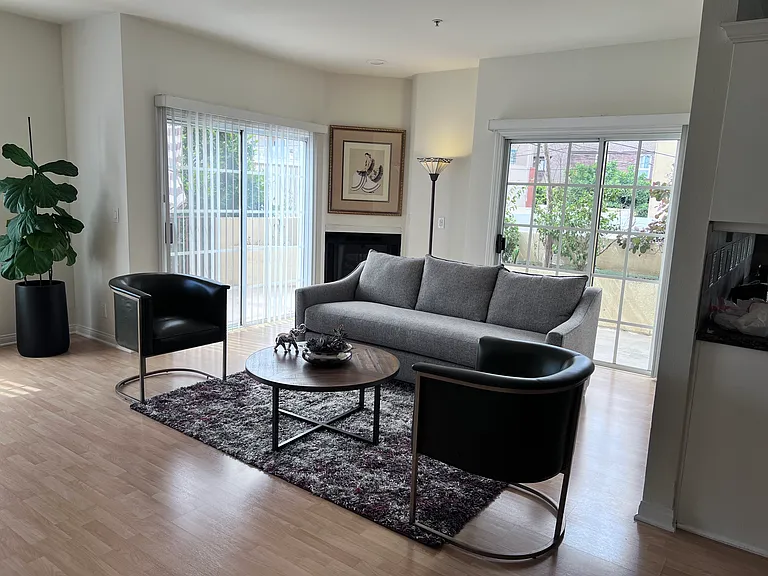 Living room with 2 sliding doors and a window. Access to patio.